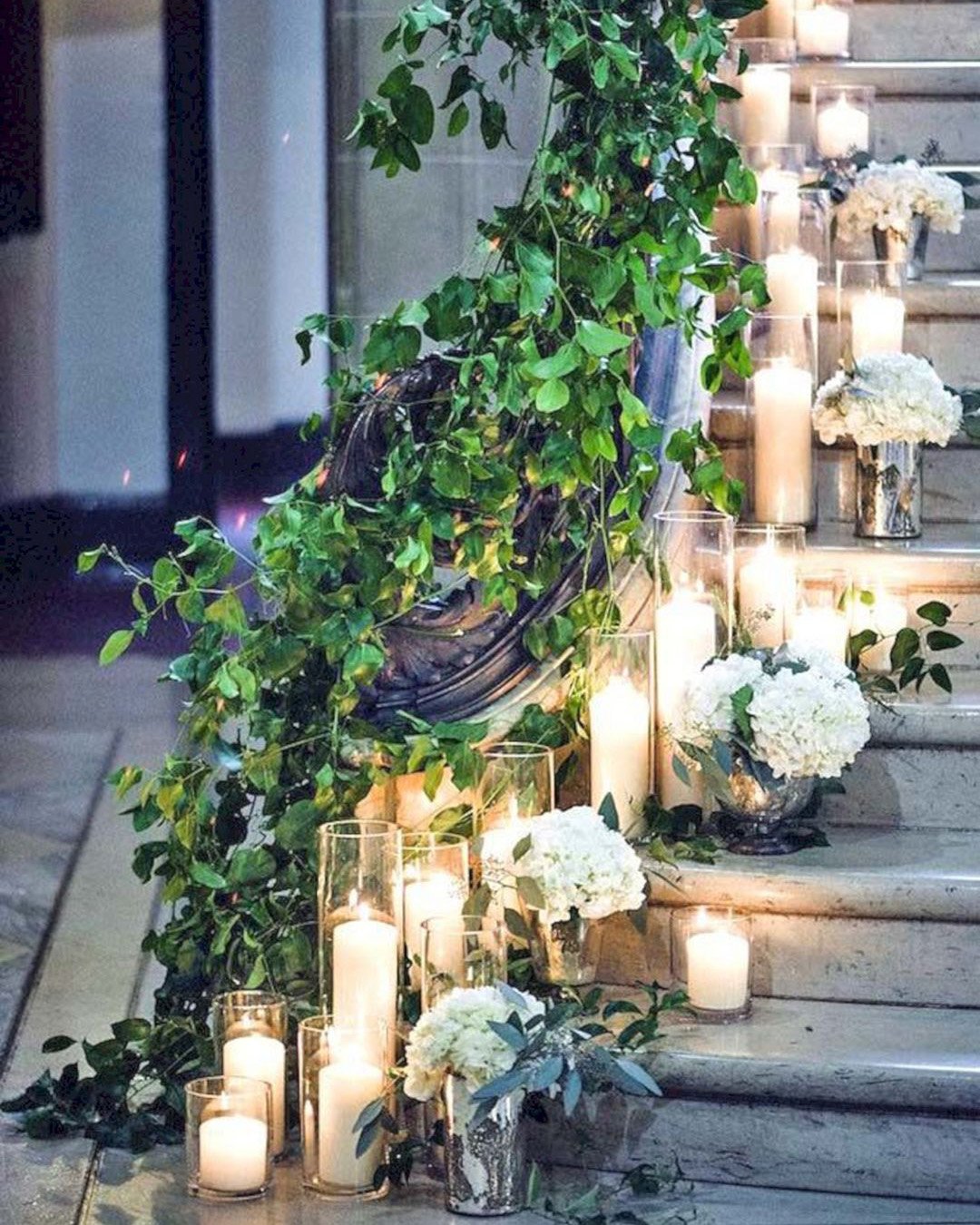 greenery wedding decor and candles on the stairs amandamegmiller
