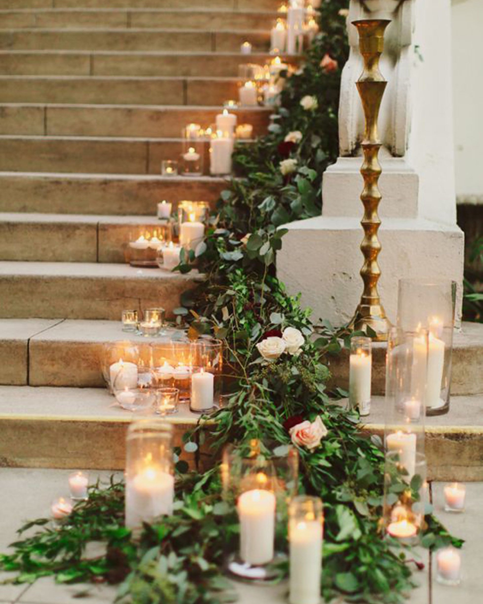 greenery wedding decor and candles roses on stairs damarismiaphoto