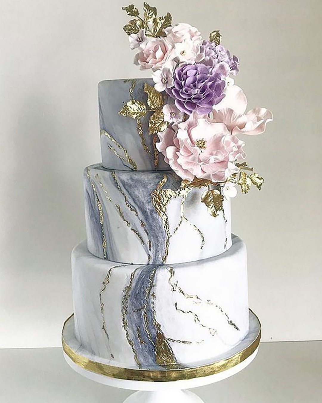 marble wedding cakes three tiered with golden elements and pink lilac flowers custom cakes toronto via instagram