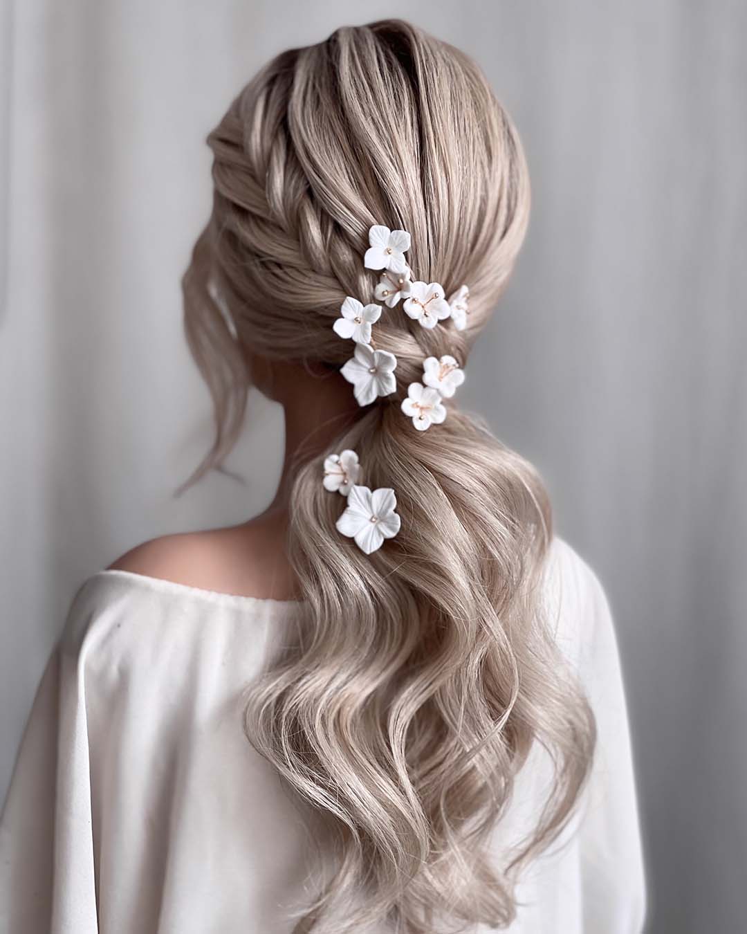 pony tail hairstyles wedding wavy low with side braid white flower pins kasia_fortuna