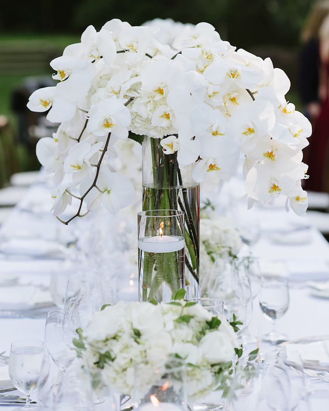 white wedding decoration ideas tall floral white center piece Caitlin O’Reilly Photography