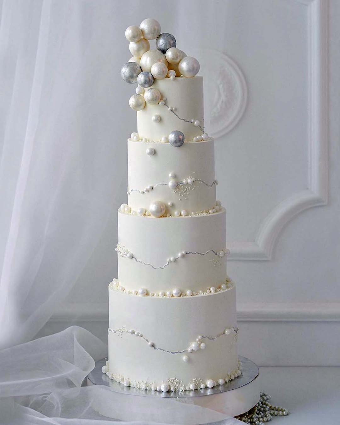 winter wedding cakes elegant tall with silver and creamy pearlescent ball nadezda_axenova
