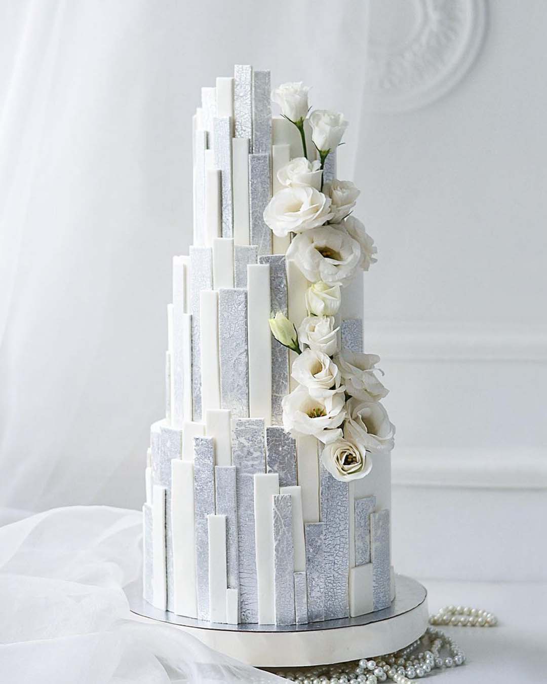 winter wedding cakes elegant tall with white flowers nadezda_axenova