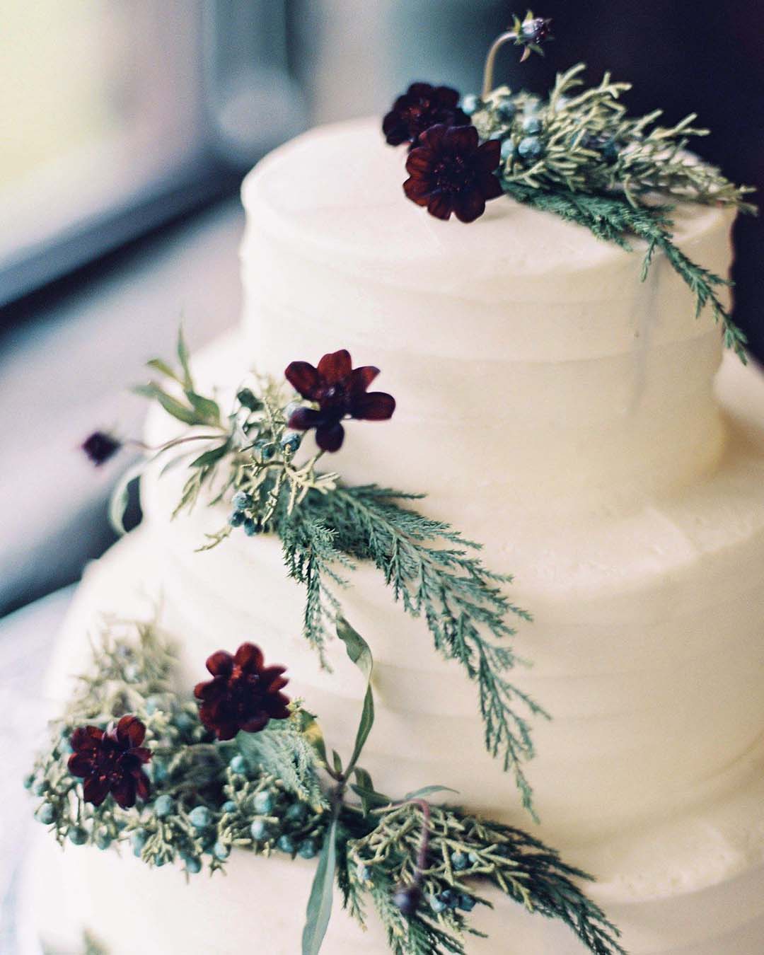 winter wedding cakes spruce branches and flowers on simple white aspenweddingphotographer