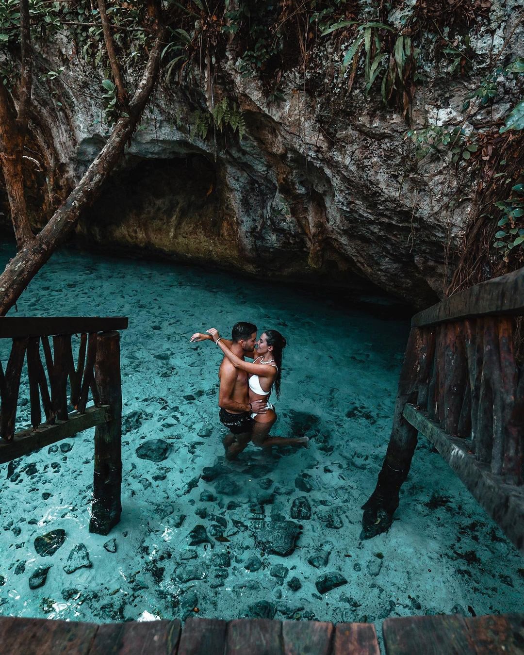 affordable honeymoon packages mexico couple in the water under the rocks explorerssaurus_