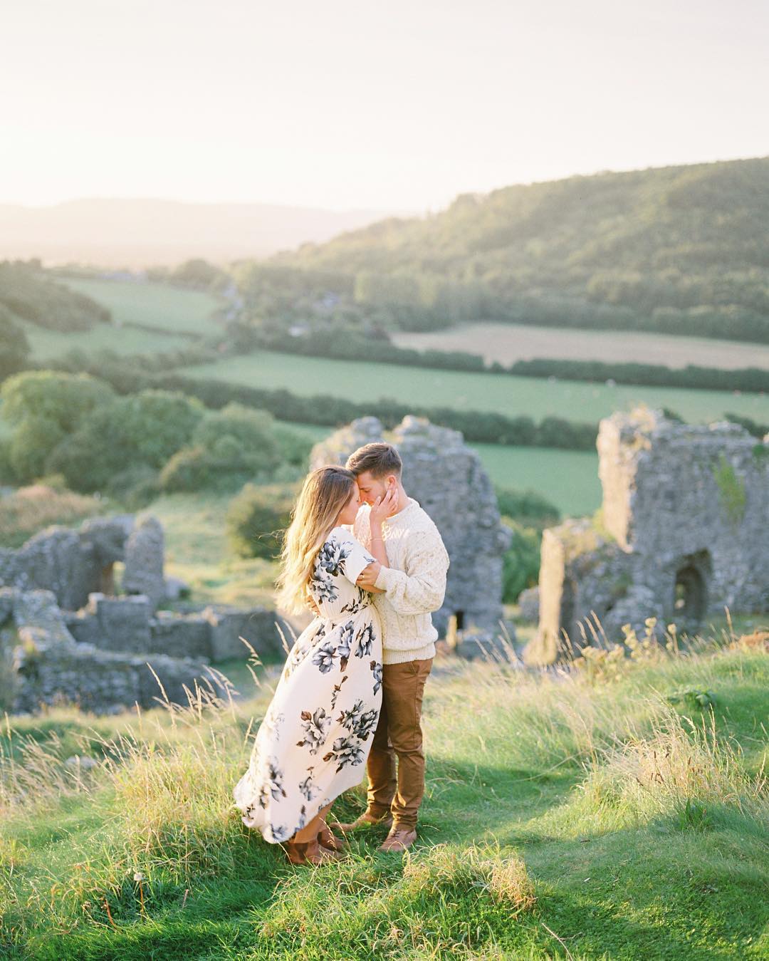 best honeymoon destinations couple hugging in the green vastness of ireland imogen