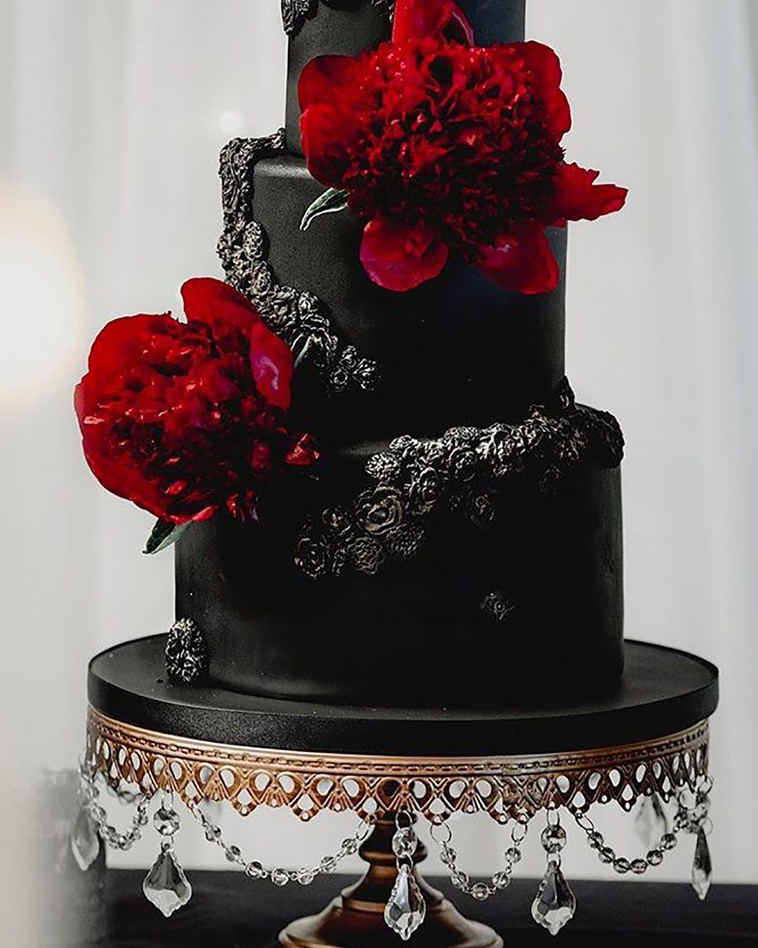 black wedding cake cake with red flowers terranycephotography