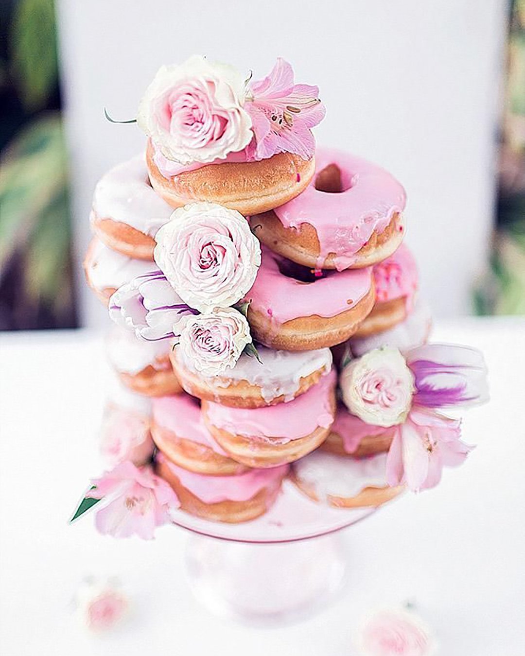 wedding cake alternatives doughnuts tower with pink icing and roses sarah bentley via instagram