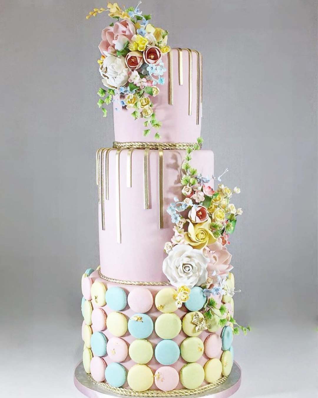 wedding cake designers tall pink drip with flowers finecakesbyzehraofficial