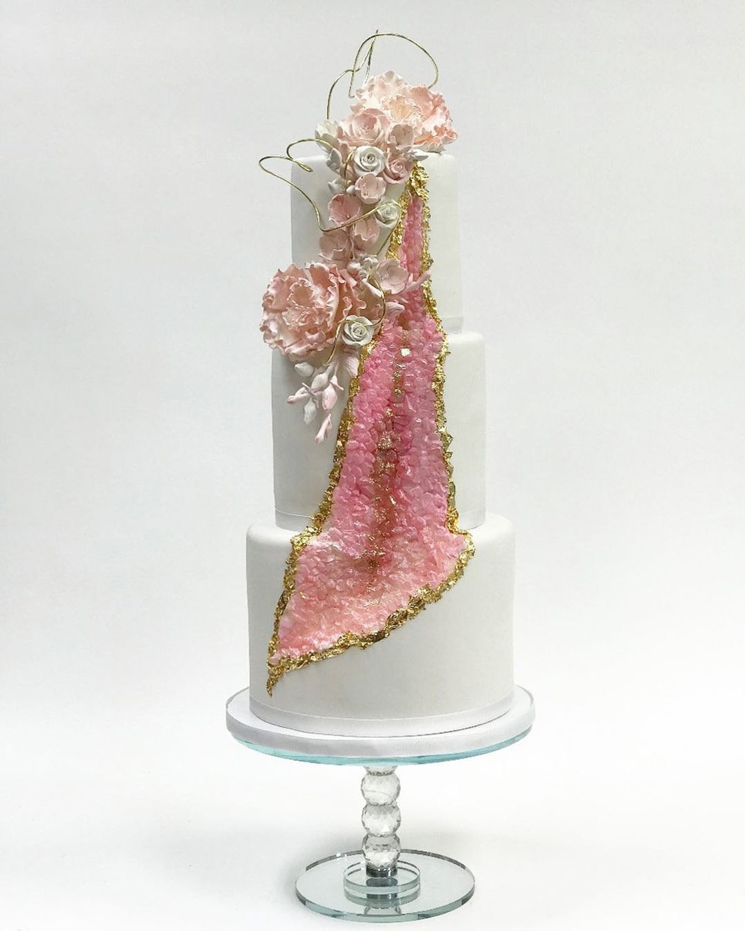 wedding cake designers tall white with pink roses and geode finecakesbyzehraofficial