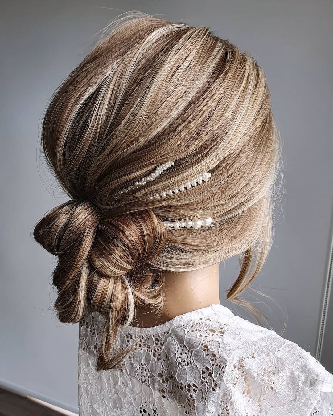 elegant wedding hairstyles casual low bun with pearls cathughesxo