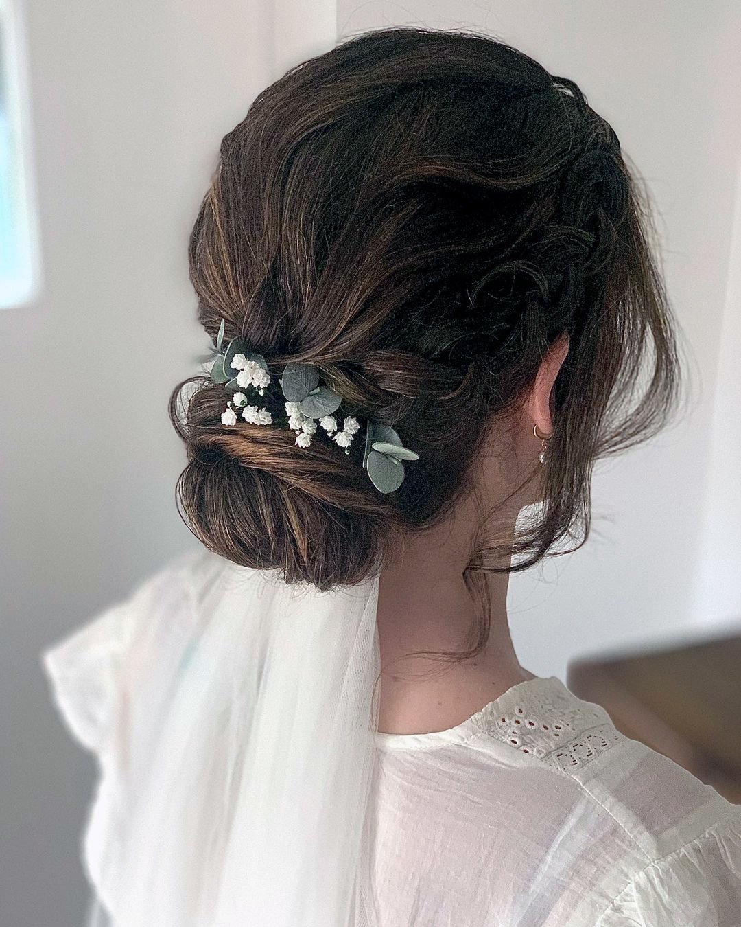 wedding hairstyles with veil braided low bun with flowers clairehartleystylist