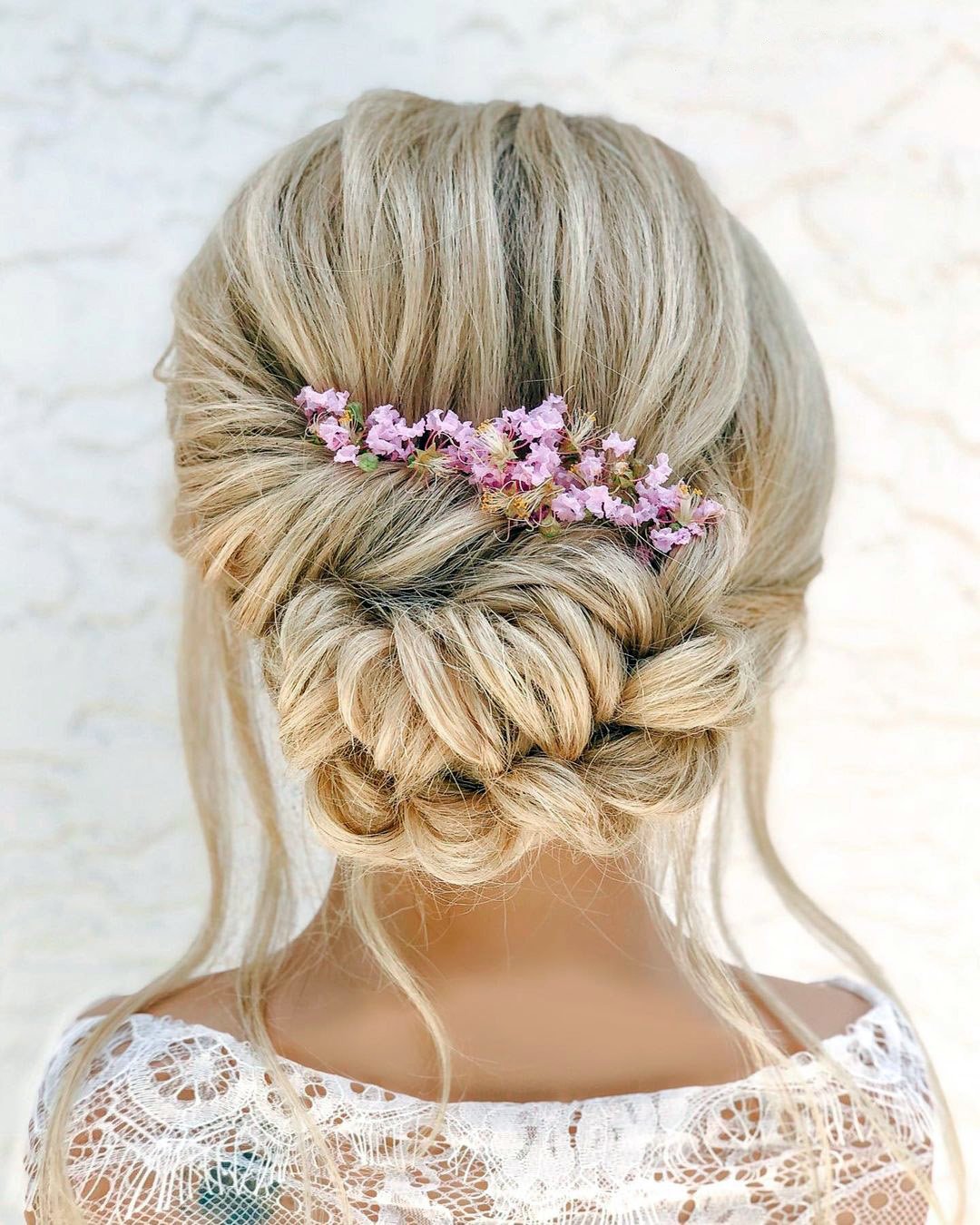 elegant wedding hairstyles textured updo with pink flowers styles_by_reneemarie