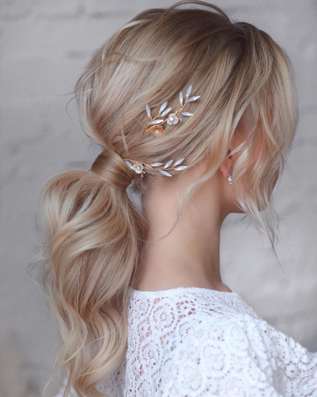pony tail hairstyles ideas for wedding low with ary curls hair_vera
