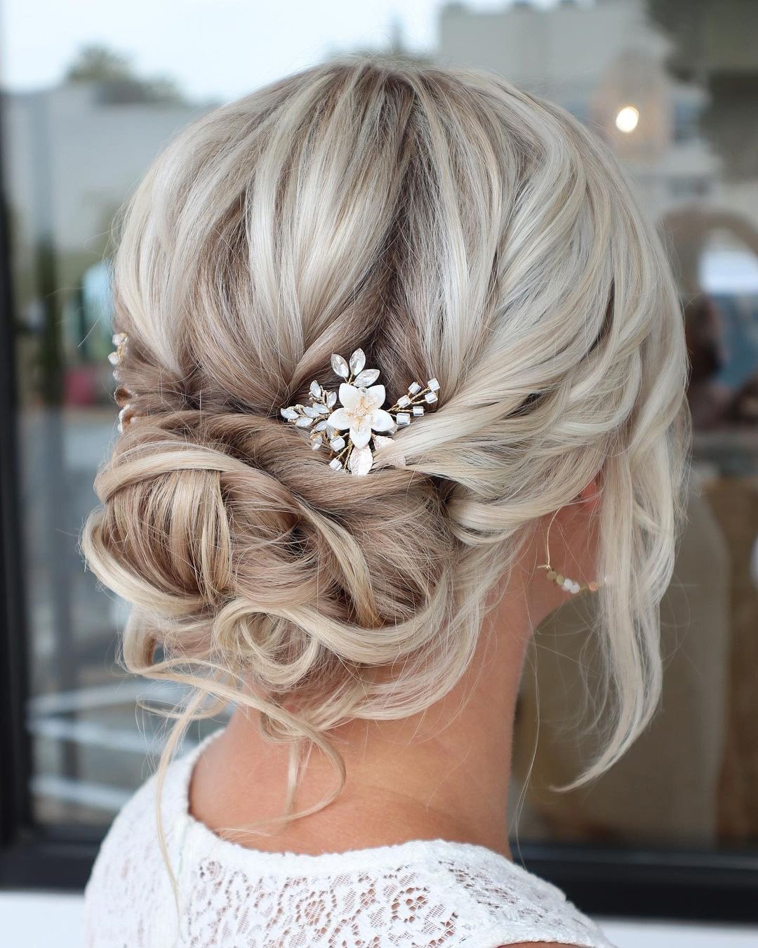 wedding hairstyles for curly hair updo blonde with flower pin reneemarieacademy