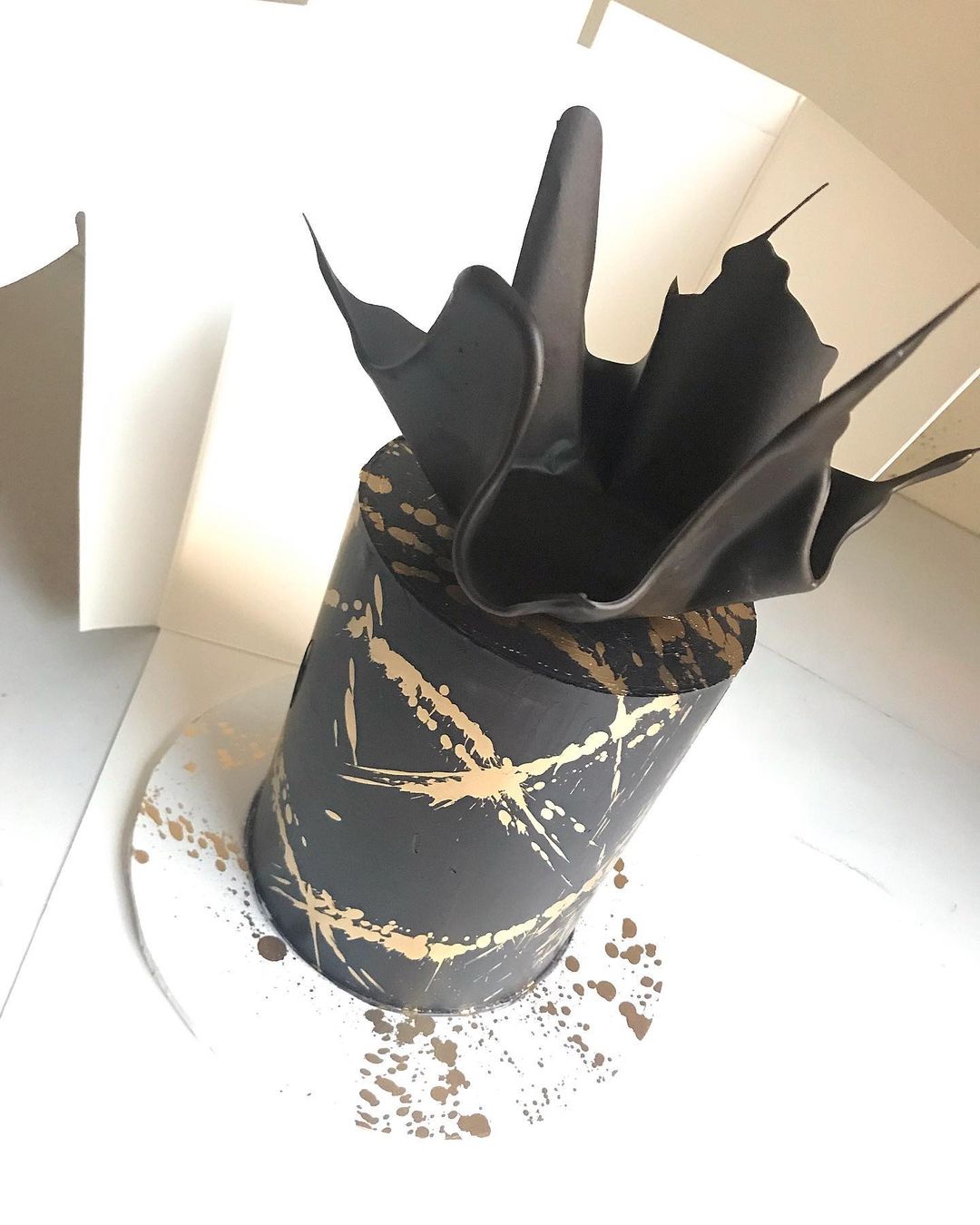 black wedding cake with gold