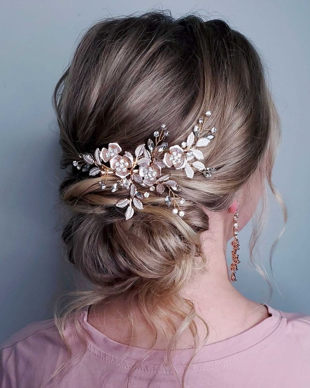 elegant wedding hairstyles slightly messy chignon with rose gold flower pin sweetvjewelry