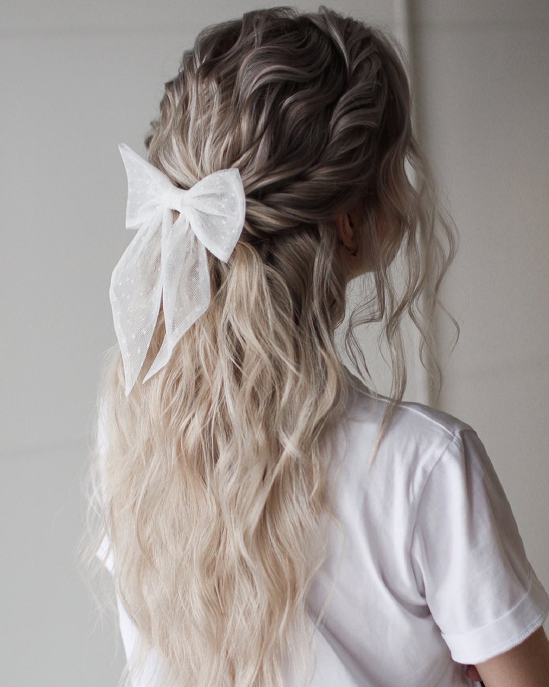 wedding hairstyles for long hair wavy half up on blonde hair with bow xenia_stylist