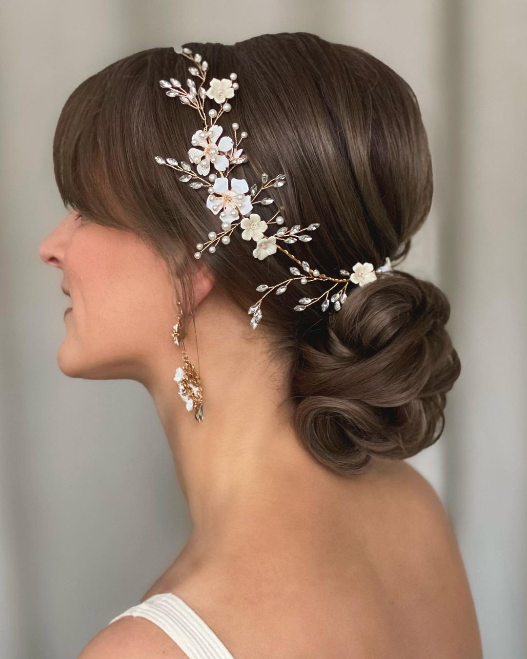 wedding hairstyles with bangs elegant low bun with flower halo kasia_fortuna
