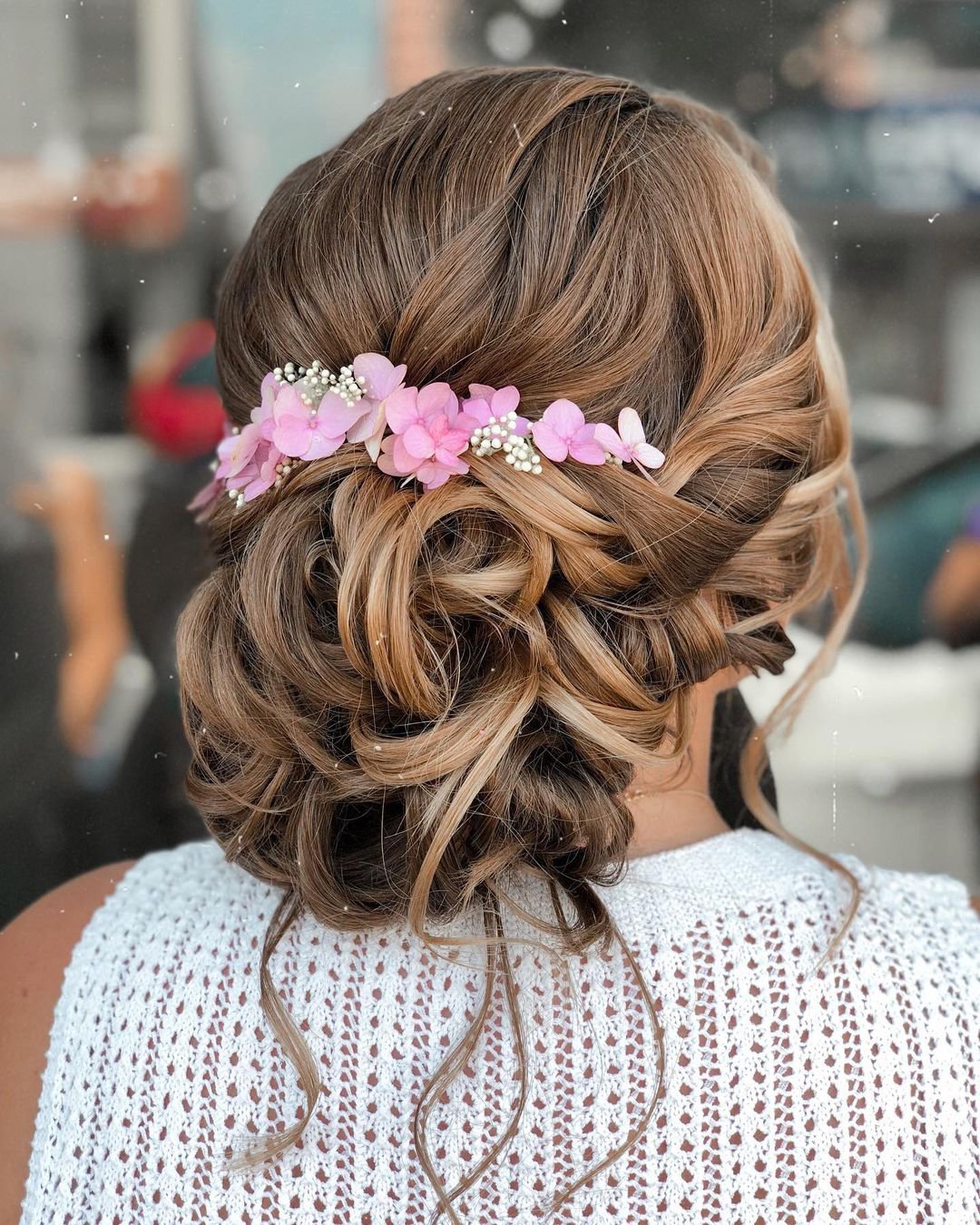 wedding guest hairstyles curly updo with pink flowers reneemarieacademy