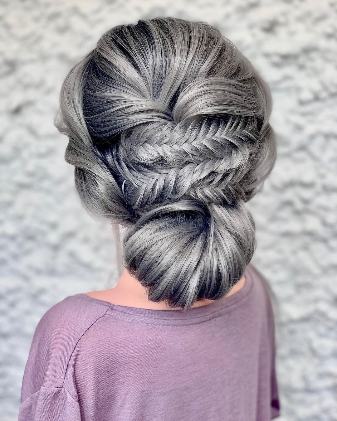 wedding hairstyles chignon with small braid accent clairehartleystylist
