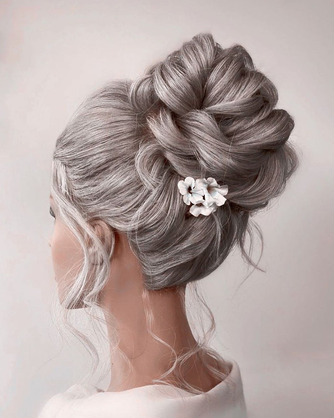 wedding hairstyles for thin hair high bun with flower pin monamieweddinghair