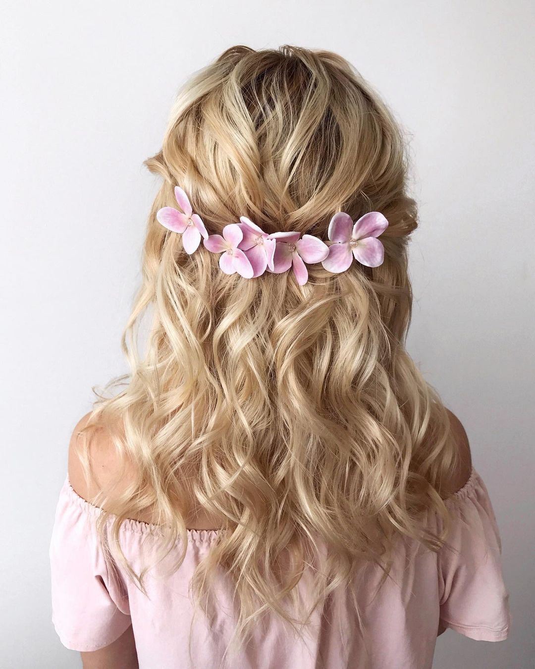 half up half down wedding hairstyles blonde curly with pink flowers samoylenko_makeup