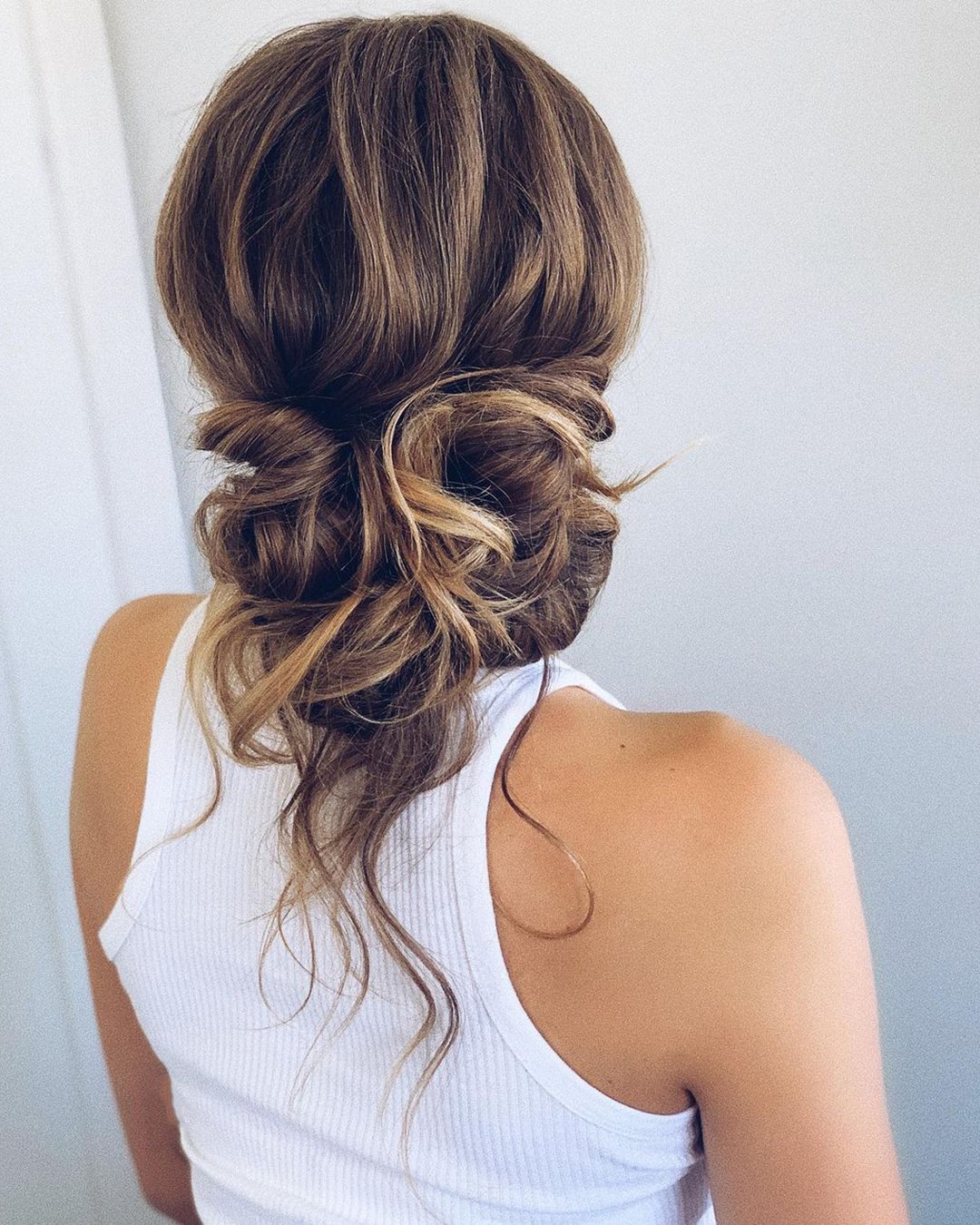 wedding guest hairstyles slightly messy updo with loose curls polishedstylejustine