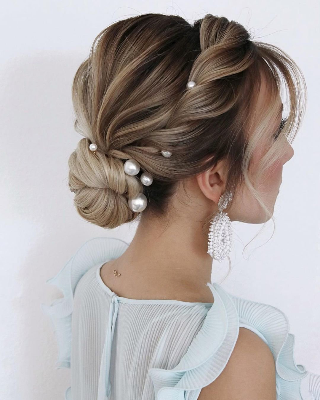 wedding hairstyles with bangs low bun with pearls juliafratichelli.bridalstylist