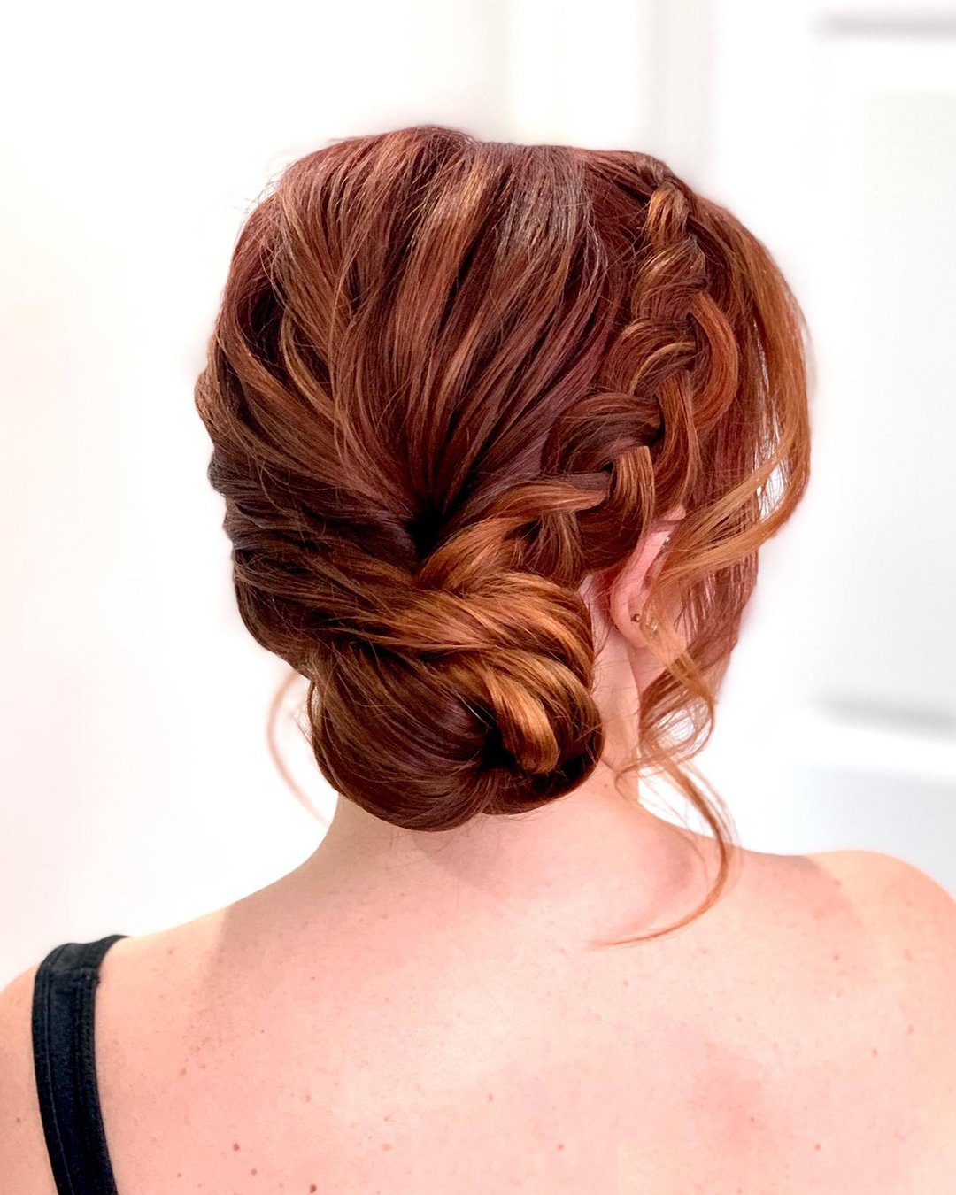 wedding updos for medium hair side bun with braid clairehartleystylist
