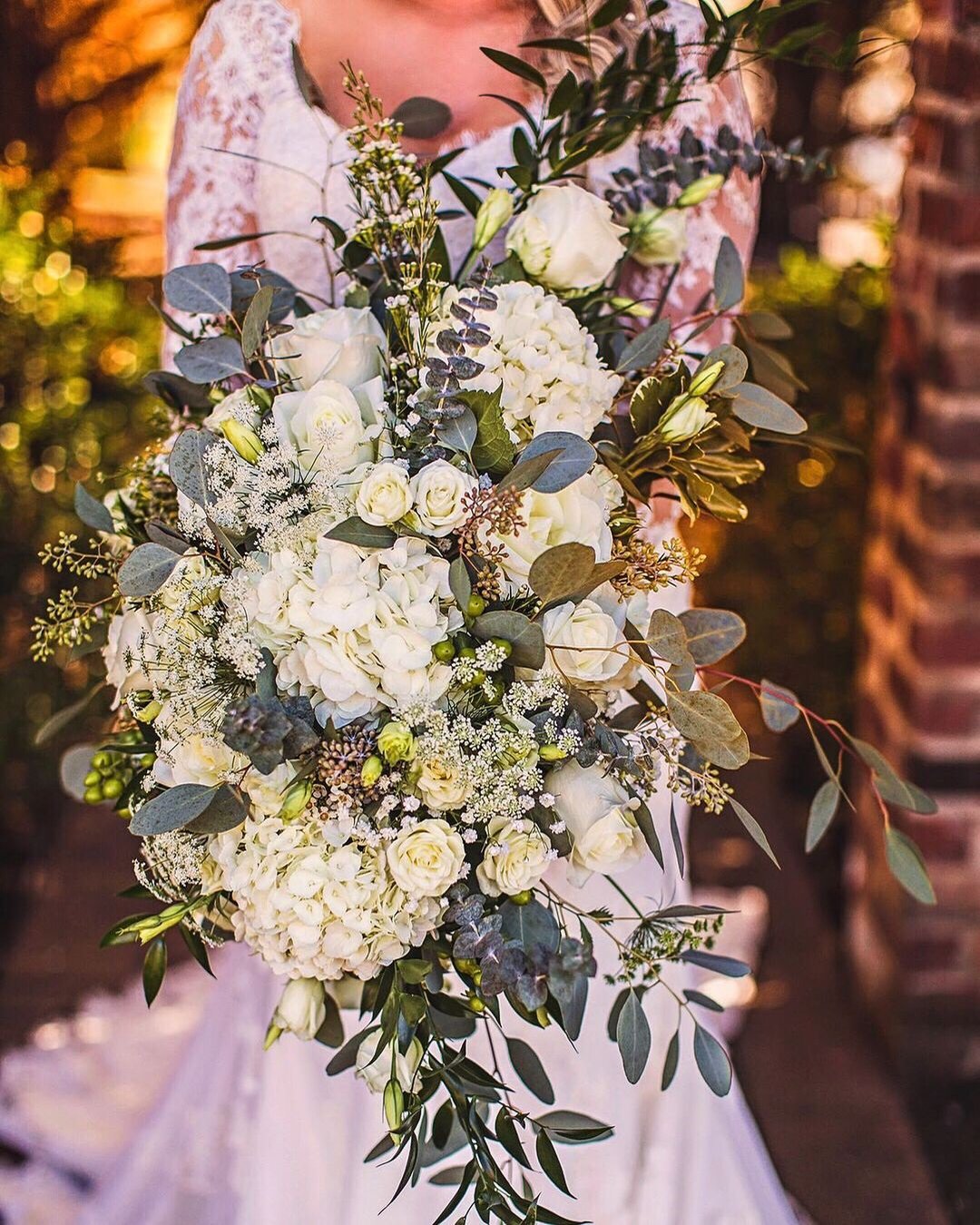 cascading wedding bouquets with greenery