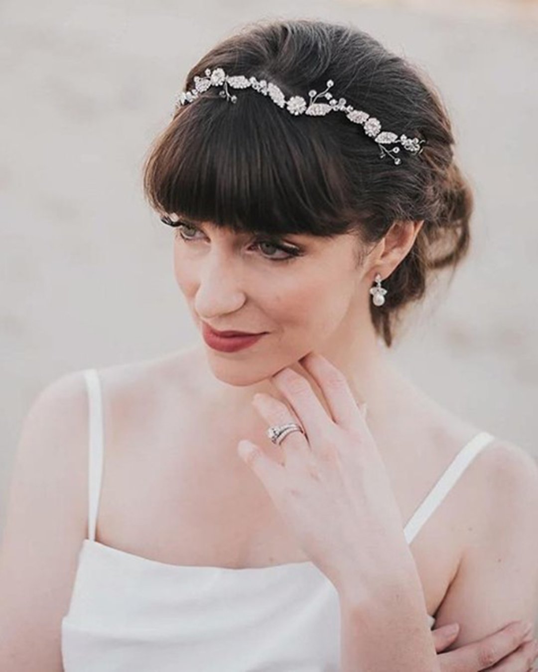 wedding hairstyles with bangs updo with crystal headband haircomesthebride
