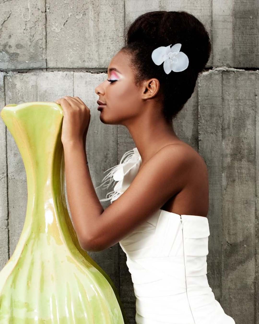 black women wedding hairstyles extremely high bun with flower pin haircomesthebride