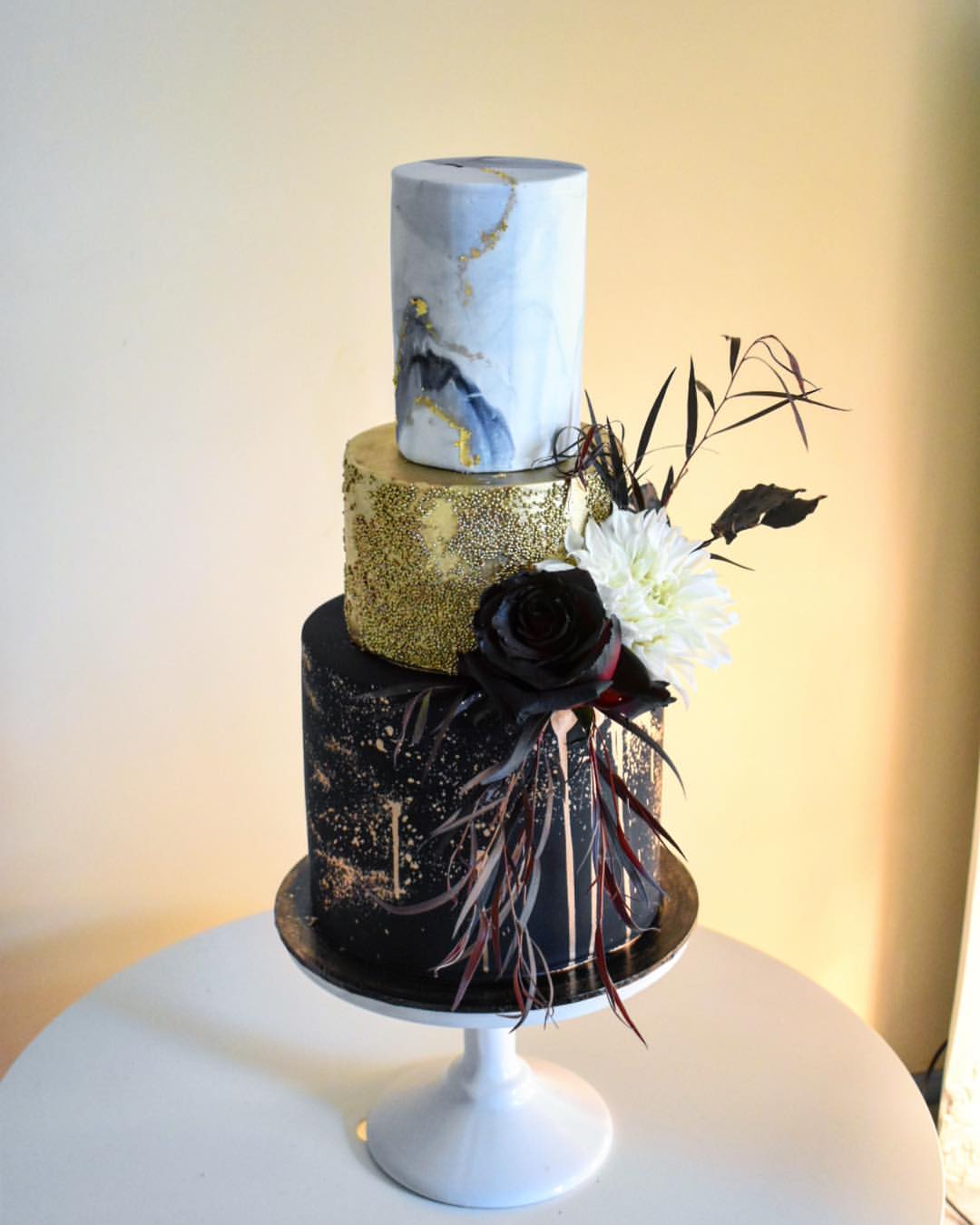 marble wedding cakes with metallic accents and black flowers