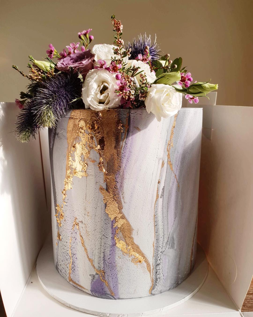 marble wedding cakes with metallic accents and flowers