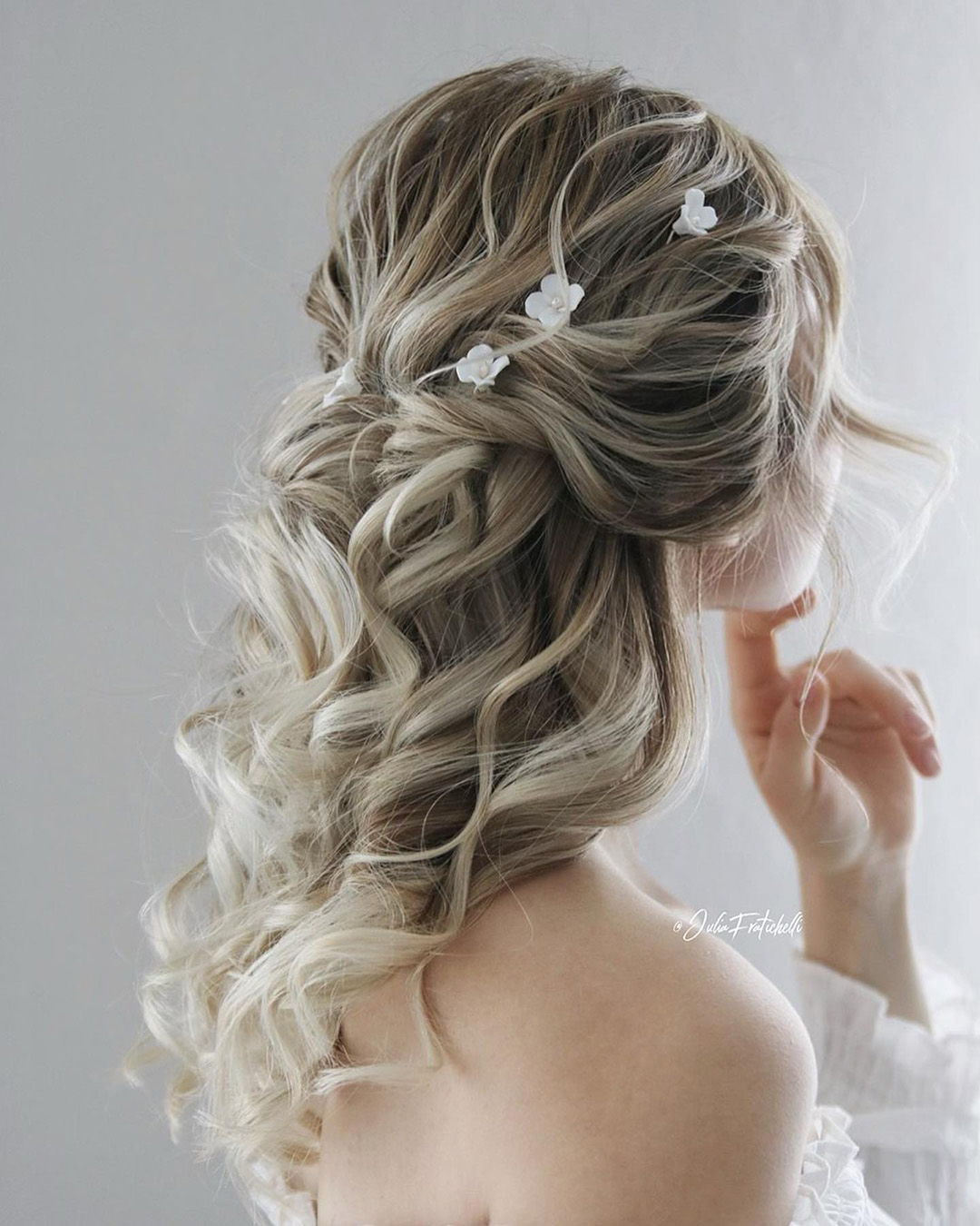 beach wedding hairstyles textured curly half up with flower pins juliafratichelli.bridalstylist