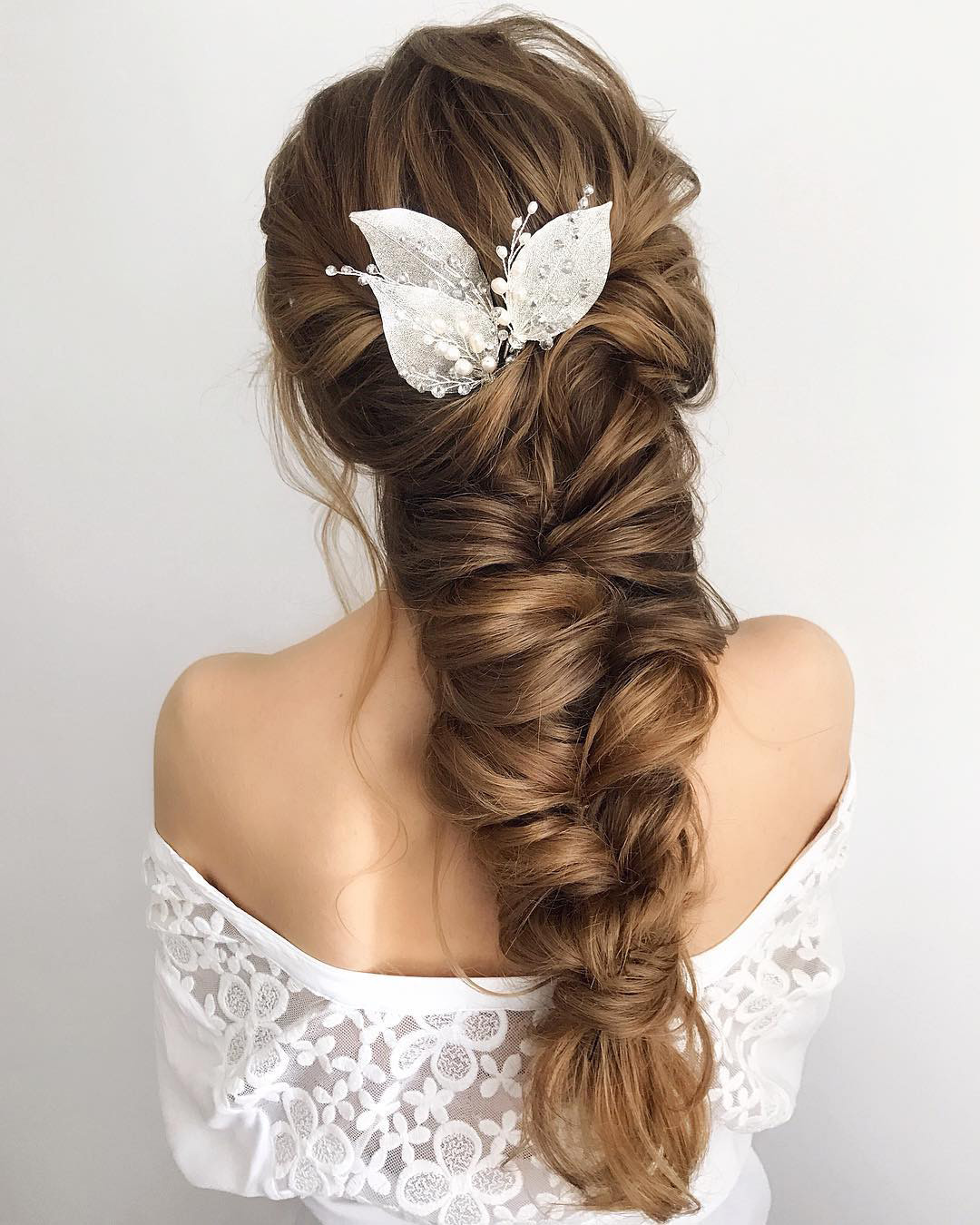 bridal hairpiece low braid with white leaves samoylenko_makeup
