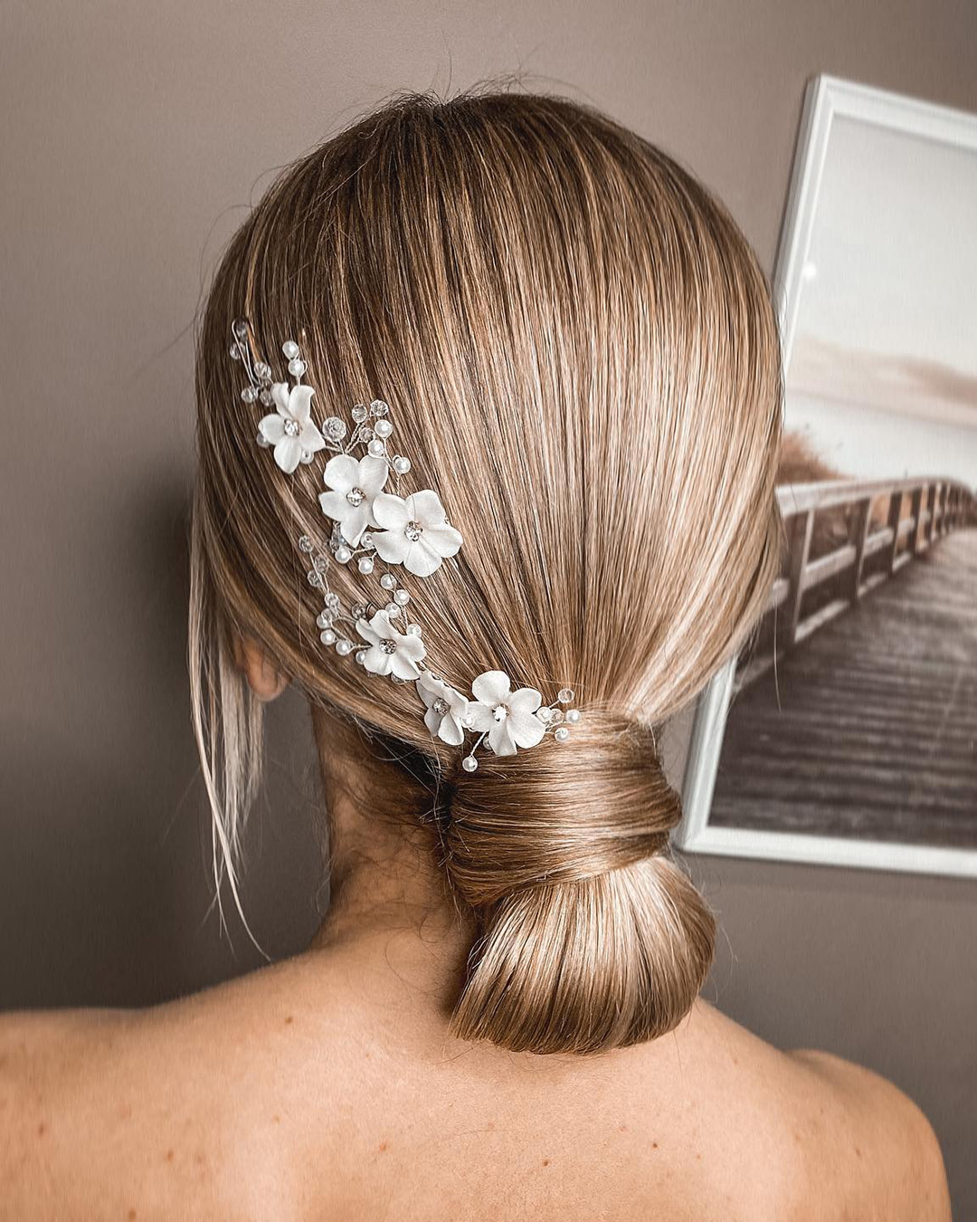 bridal hairpiece simple low chignon with flower wine tatistylespb