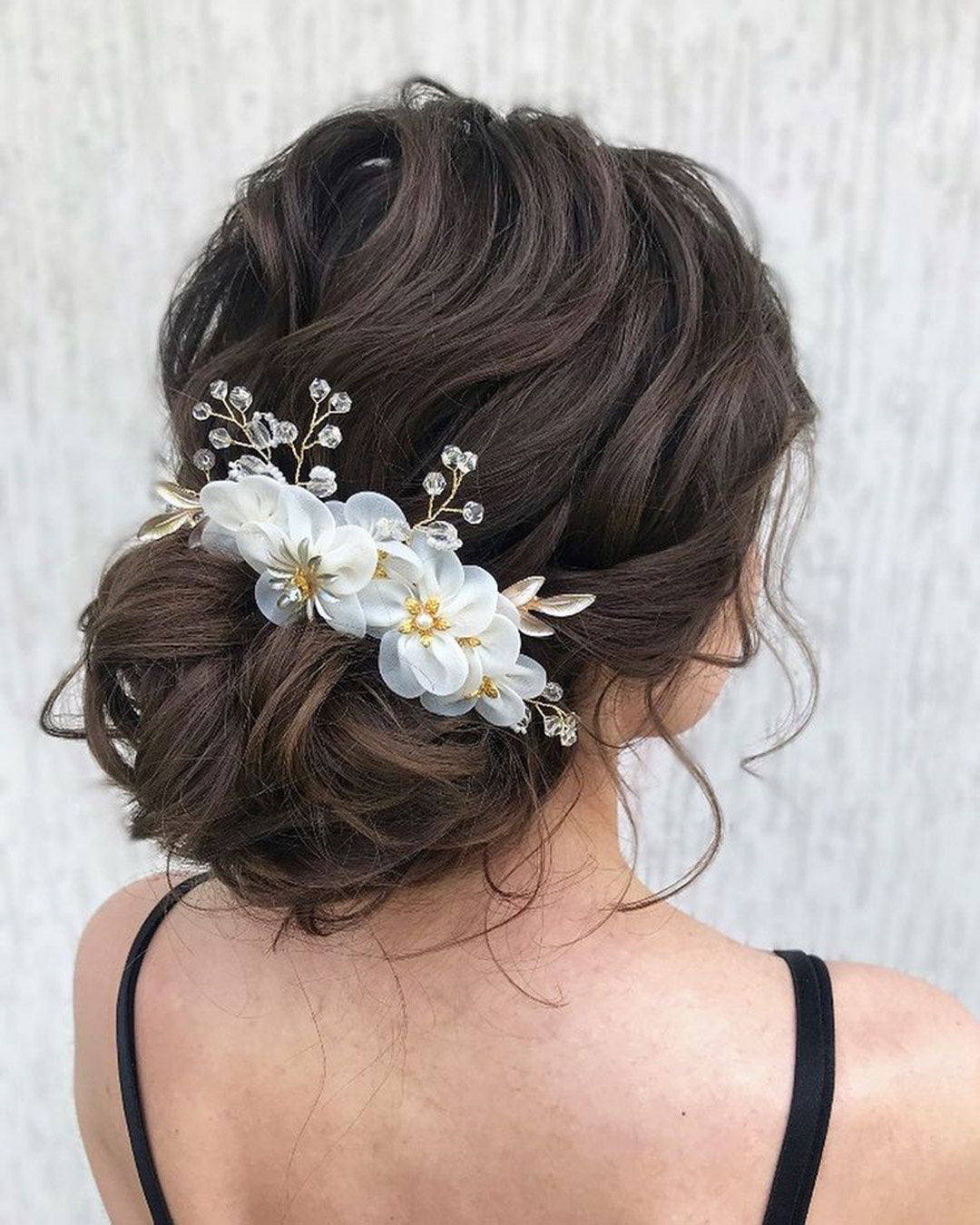 bridal hairpiece textured volume low bun with flowers julia_alesionok