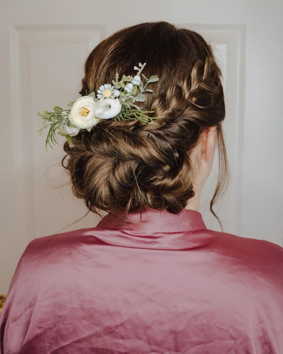 beach wedding hairstyles messy low bun with braids and flowers rebecca.murphy.beauty