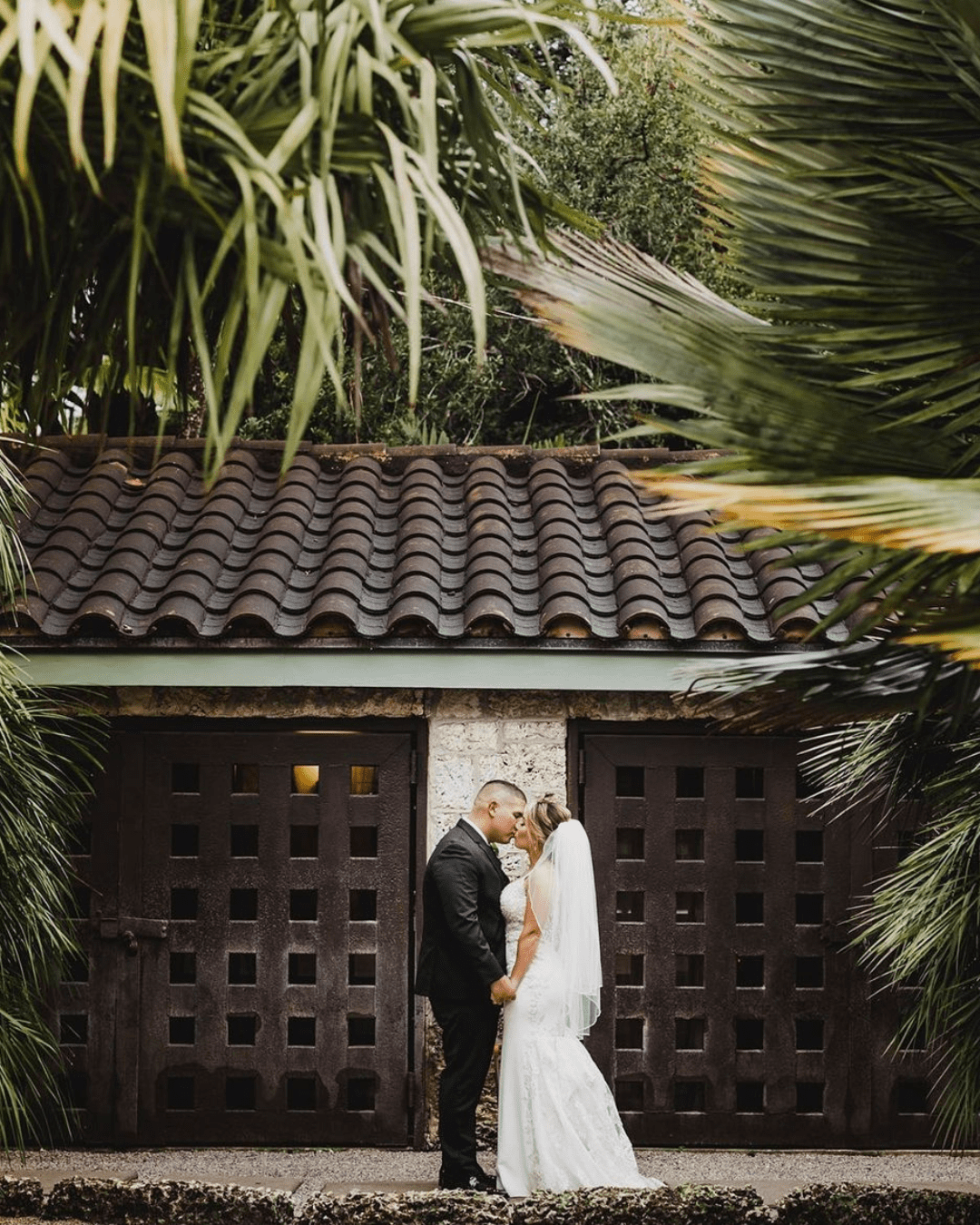 best wedding venues in florida groom kissing the bride in the woods